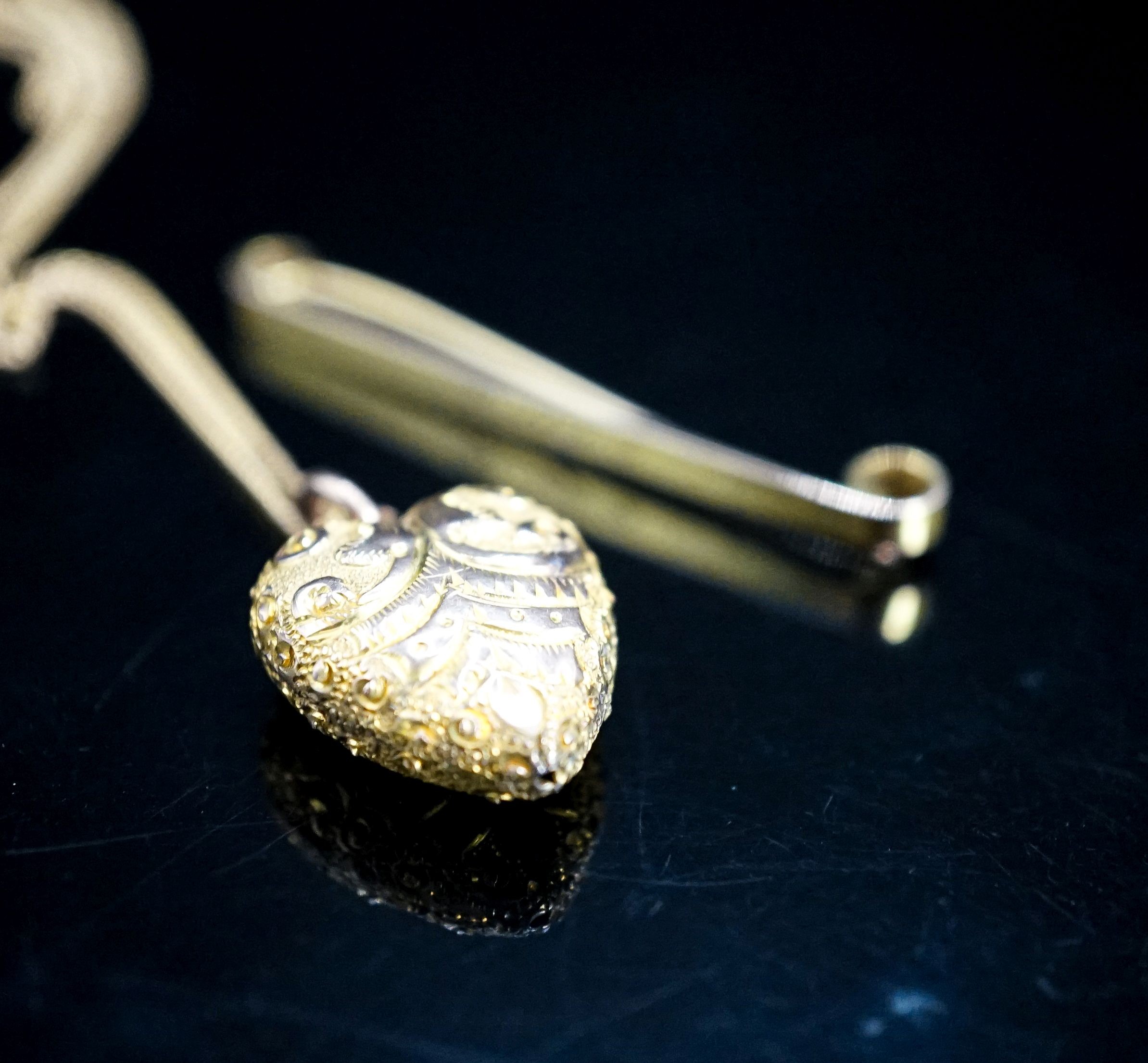A 9ct tie pin and a yellow metal heart shaped pendant on a 9c fine link chain, gross weight 5.9 grams.